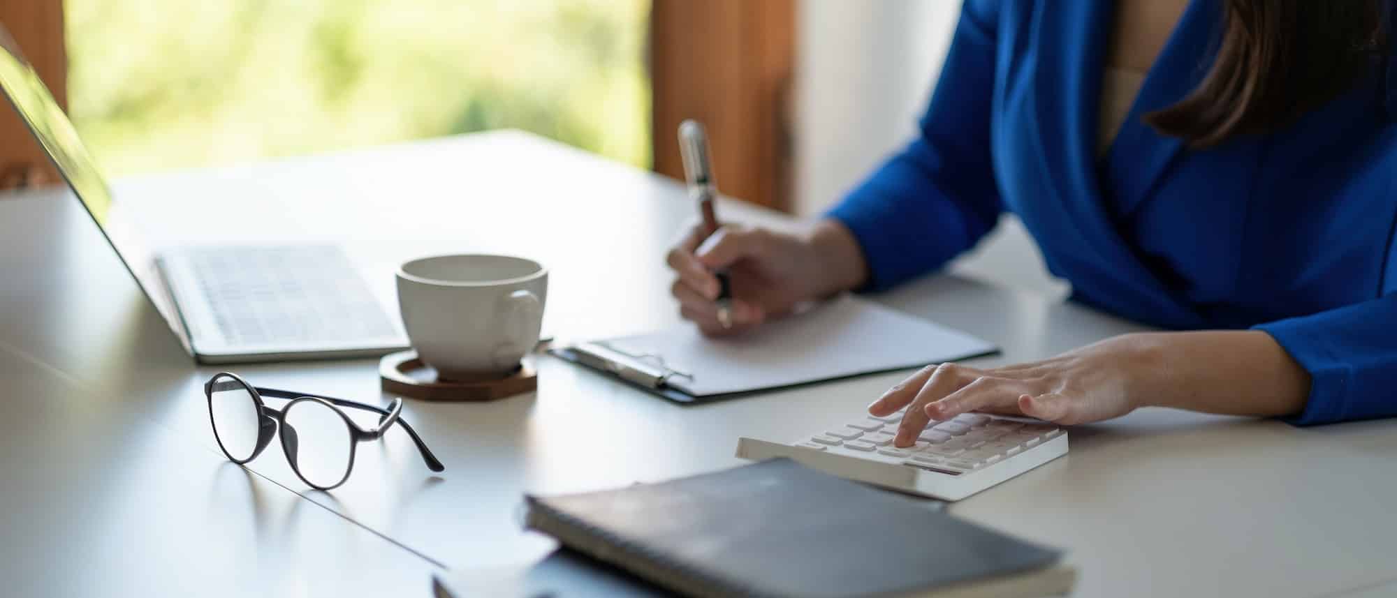 accounting is recording the company's financial growth statistics using calculator for reviewing and